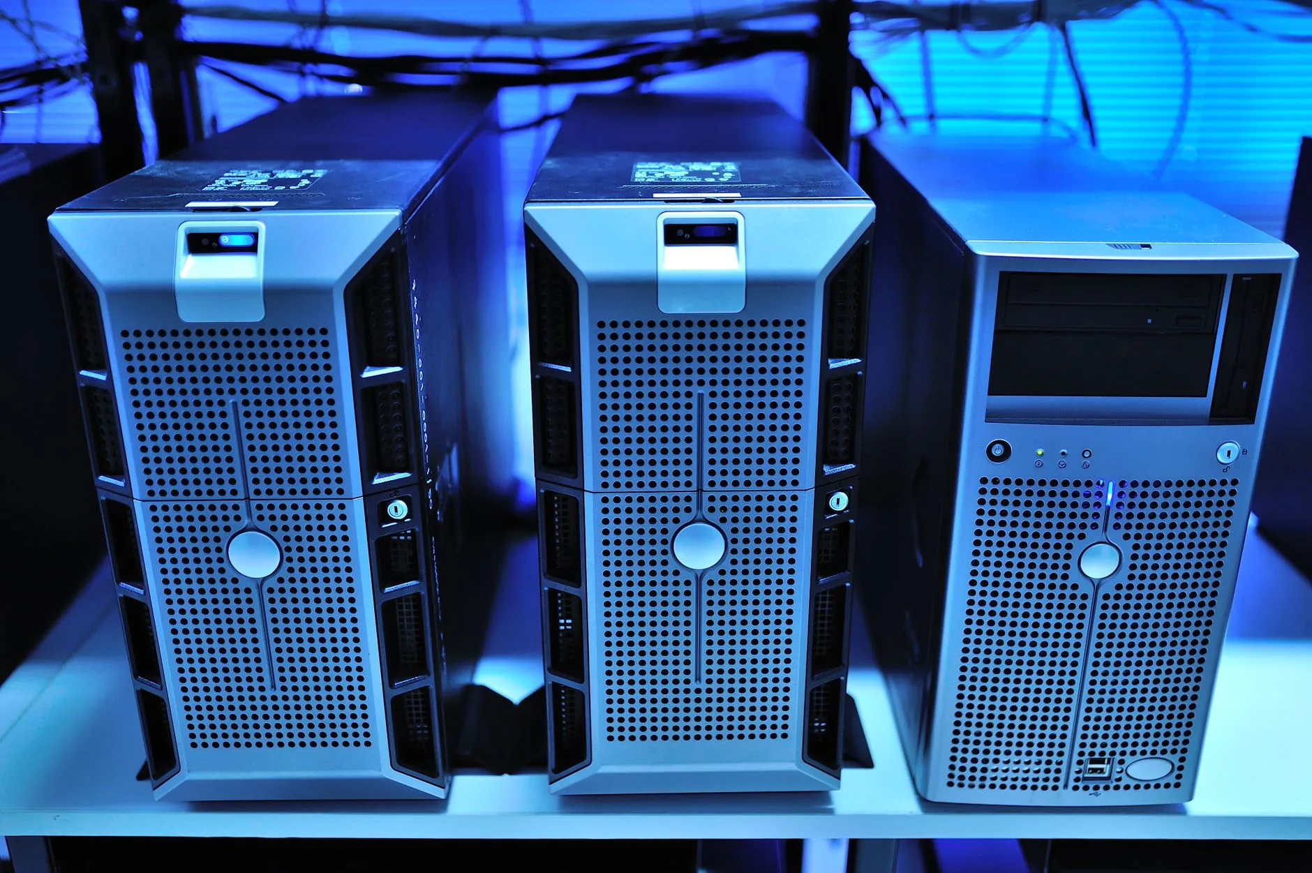 Modern enterprise server racks illuminated with blue LED lights in a secure facility